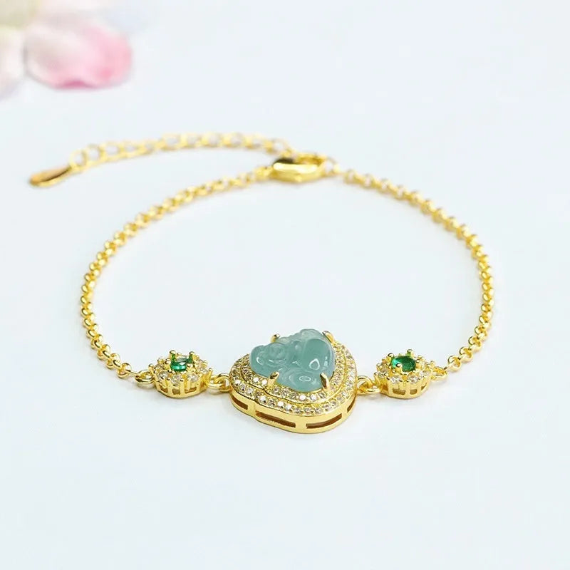 Close-up of a blue jade Maitreya Buddha pendant on a women's bracelet.