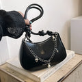 One shoulder crossbody commuter bag in white with sewing thread and chain detail, horizontal square shape