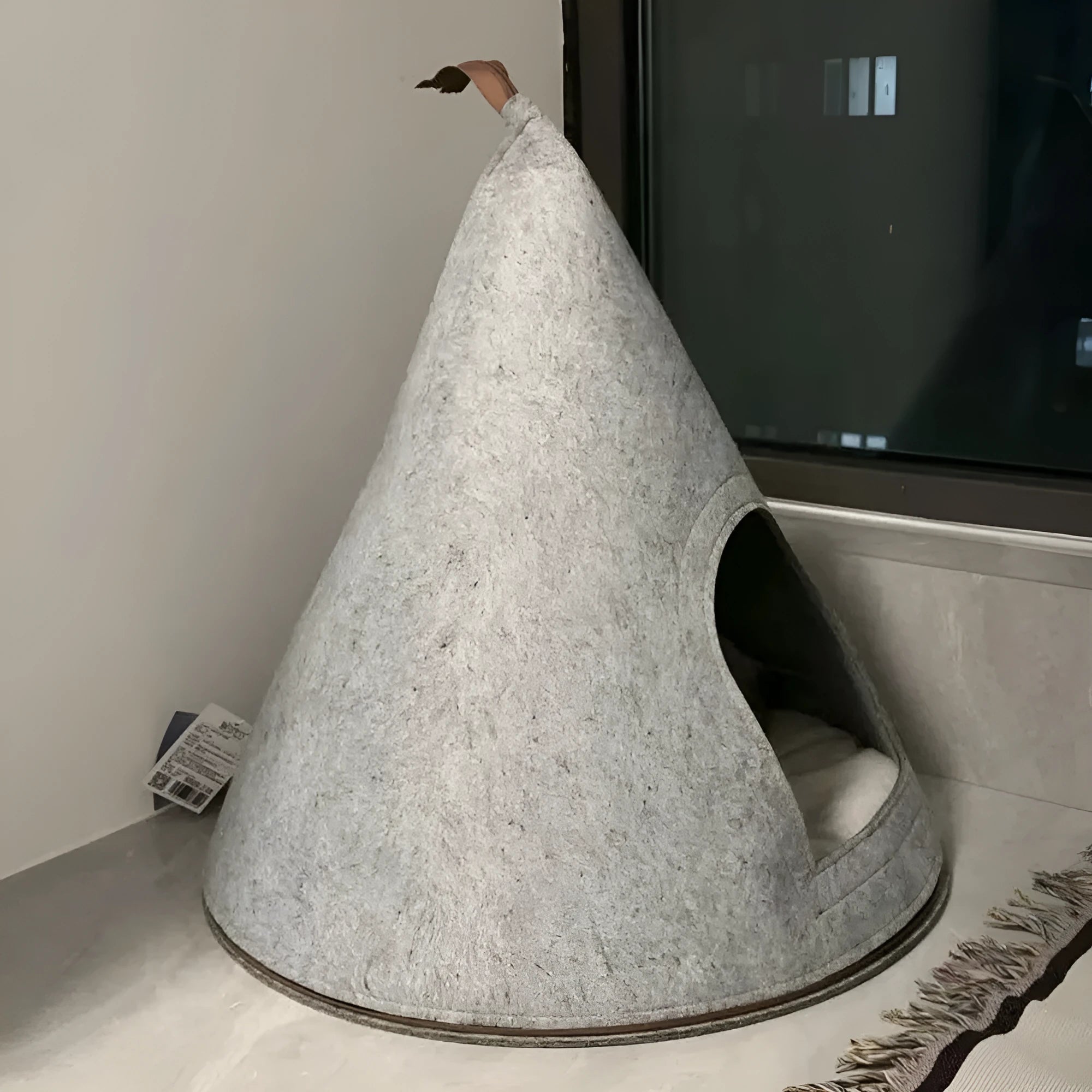 Grey cone-shaped felt cat house measuring 50cm wide with enclosed tent design