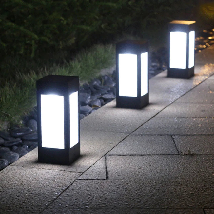Waterproof solar-powered LED garden light installed on an outdoor wall.