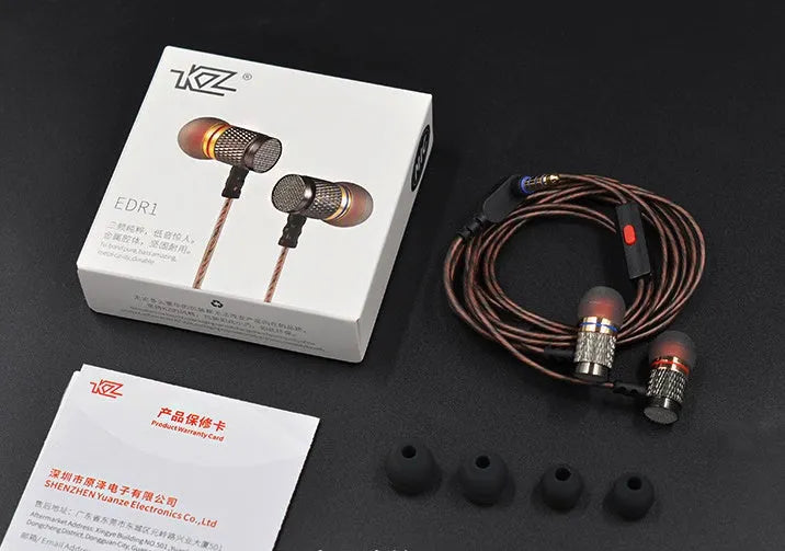 Close-up of wired in-ear headphones with metal earpiece, silicone cable, and 3.5mm L-bend plug.