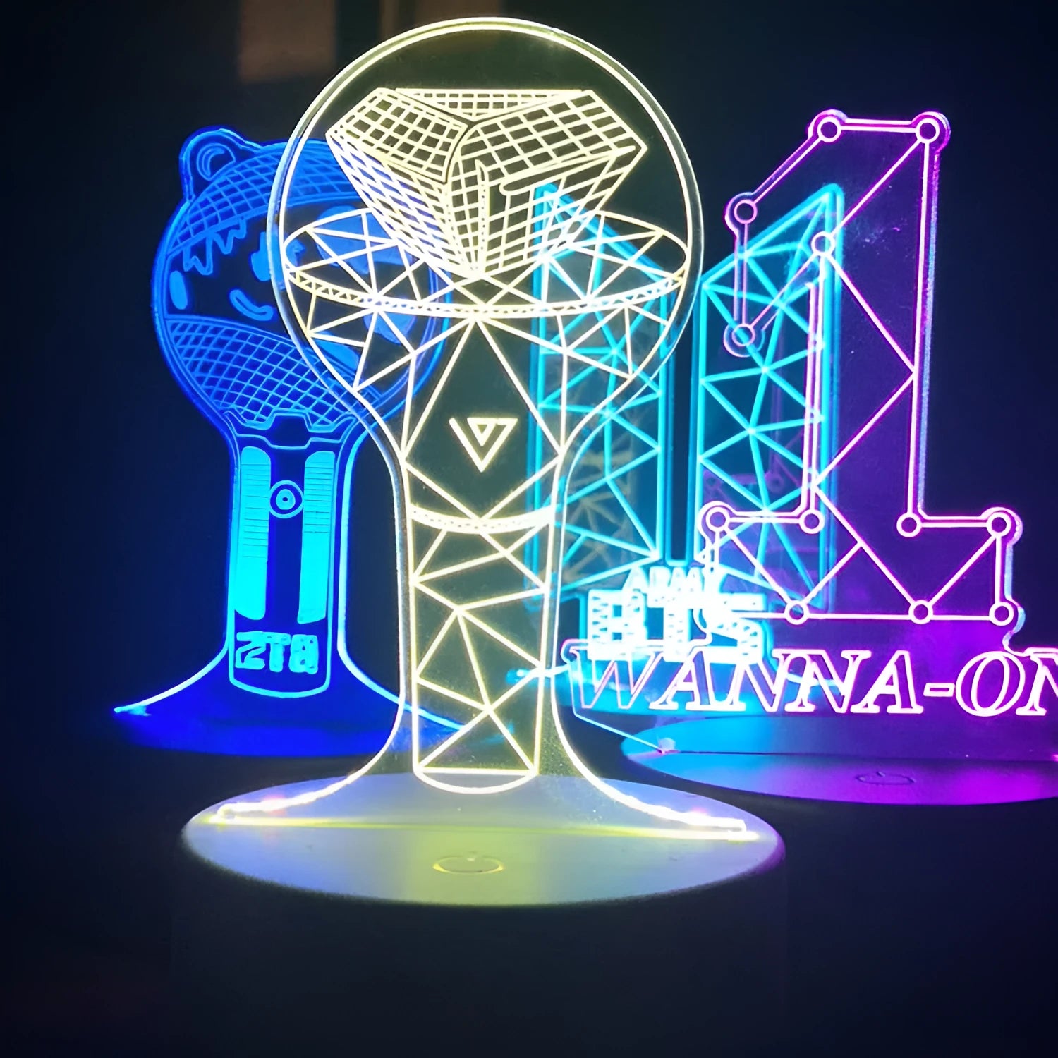 Transparent acrylic display stand showing illuminated BTS Light 101 Tower Gem collectible lamp.