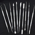Stainless steel clay knife set of 10 pieces with photo colour finish on a neutral background