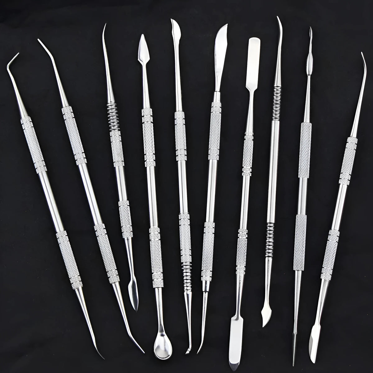 Stainless steel clay knife set of 10 pieces with photo colour finish on a neutral background