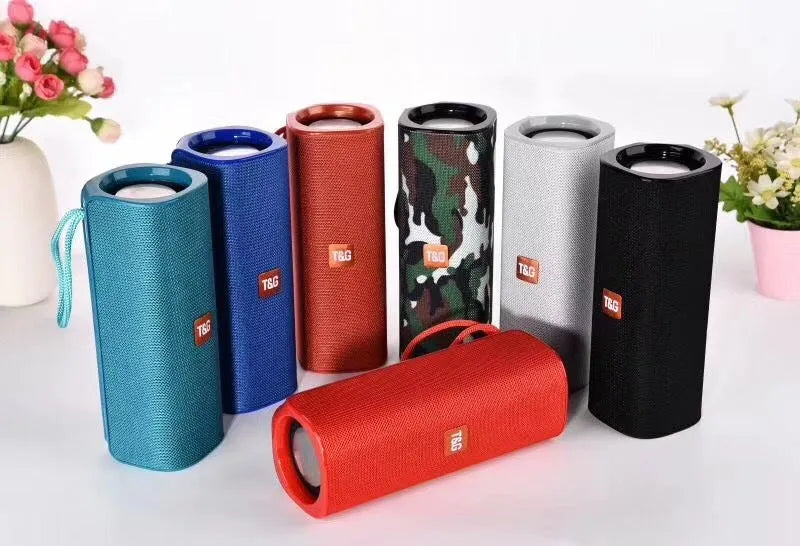 Fabric-covered portable Bluetooth speaker with USB port and control buttons