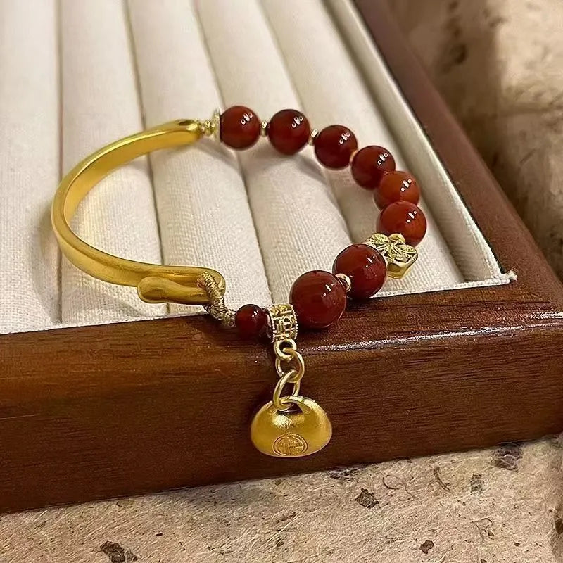 Golden south red agate character ingot bracelet with lucky bag charm design for women