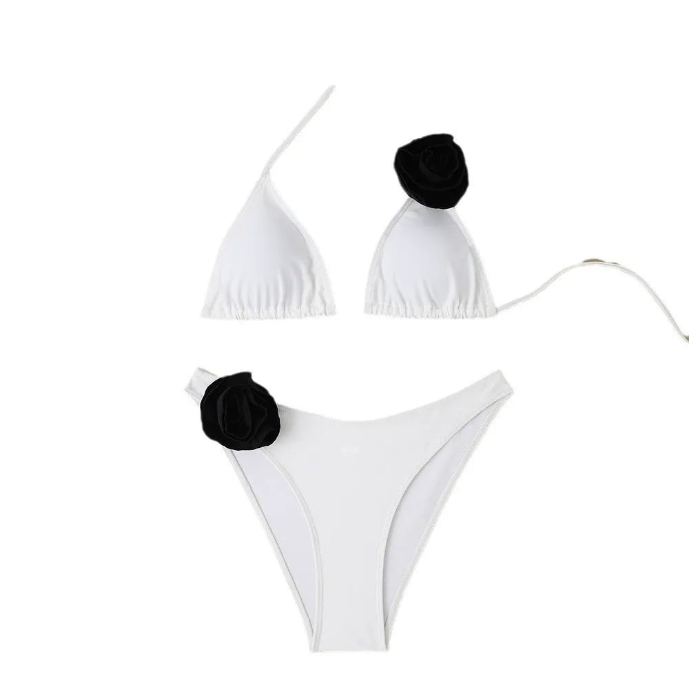 Women's black and white floral bikini with three-dimensional flowers and lace-up front