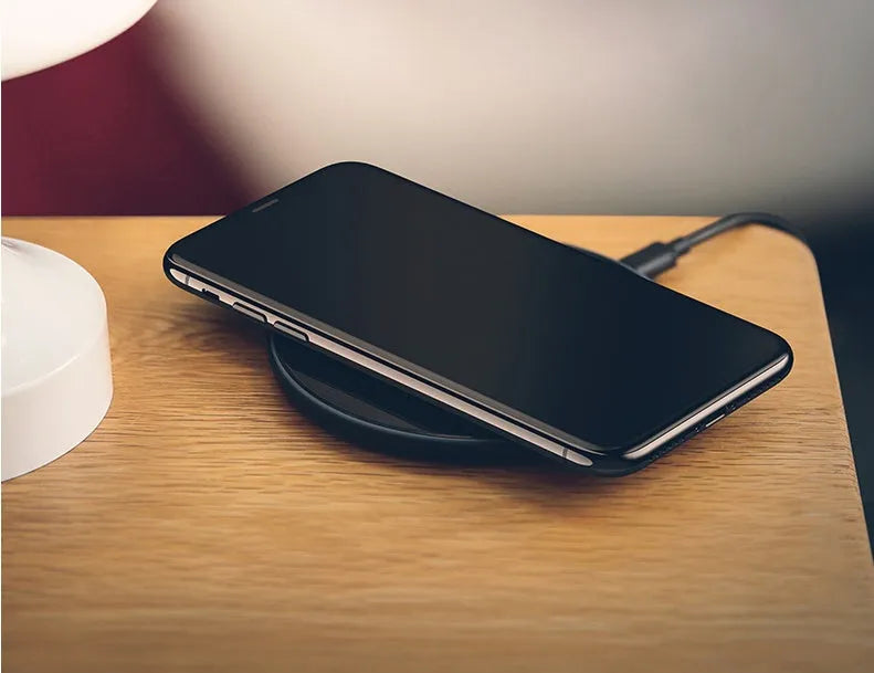 Glass disc wireless charger for smartphones in black or white with charging indicator