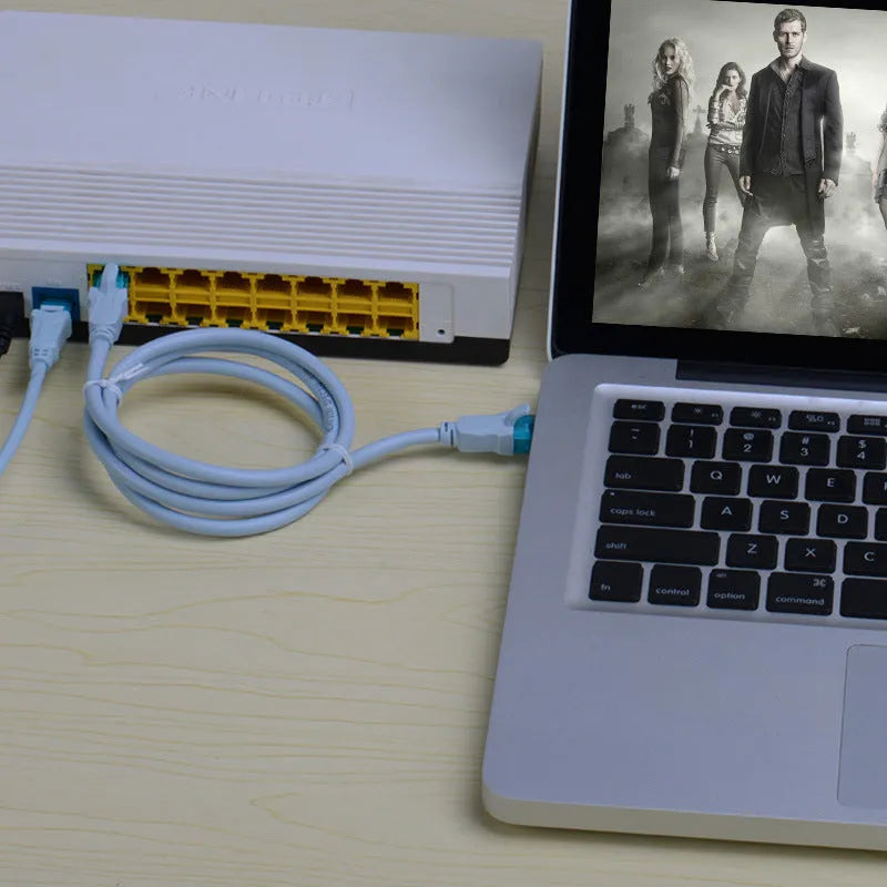 Ice blue CAT5e network cable with gold-plated RJ45 connectors on a light background
