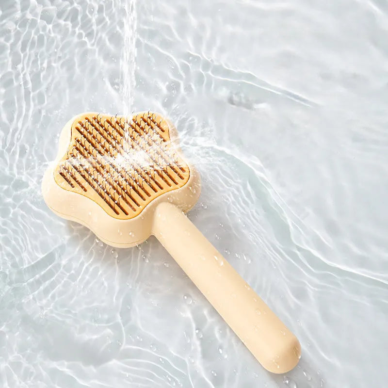 Green or yellow handheld self-cleaning magic wand pet comb with stainless steel needles.