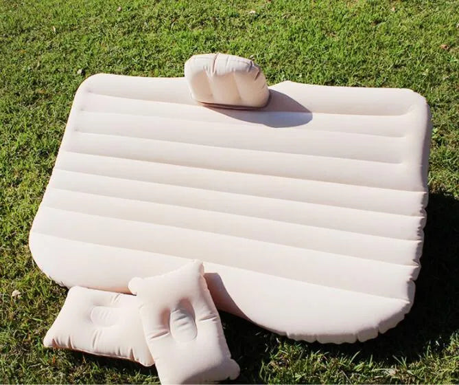 Universal inflatable car bed with flocked cloth, shown with two pillows and a pump.