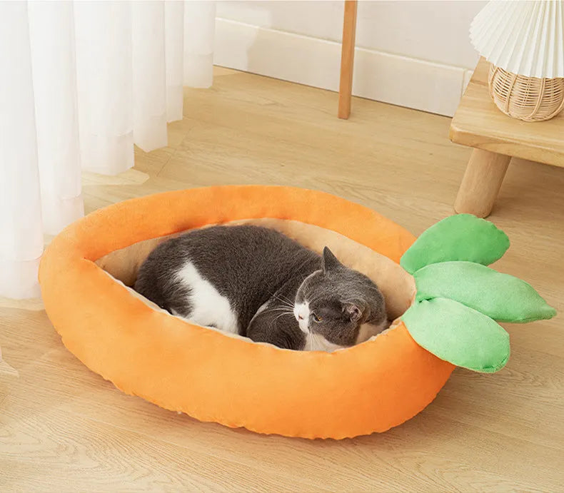 Carrot-shaped dog nesting bed with a soft, light-coloured blanket inside, suitable for a small dog.
