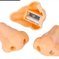 Flesh colour geometric plastic pencil sharpener with large nostril on a white background.