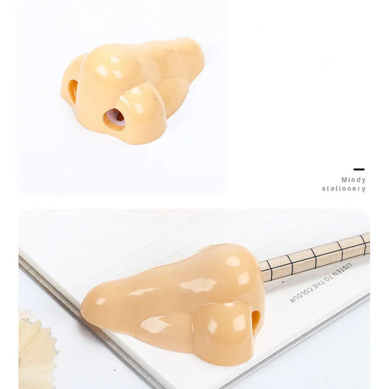 Flesh colour geometric plastic pencil sharpener with large nostril on a white background.