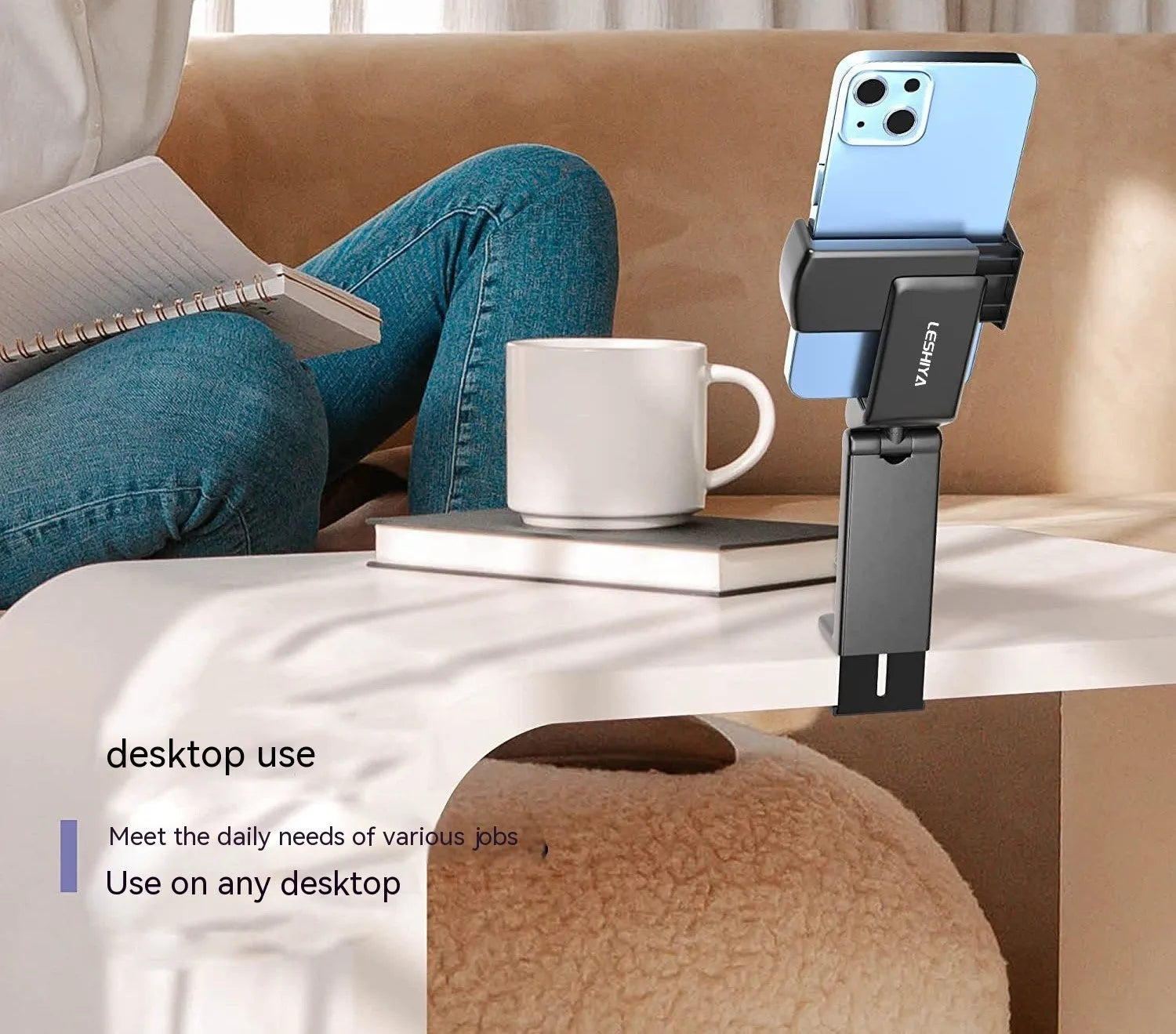 Black foldable rotating universal phone holder shown open on a desk, holding a smartphone.