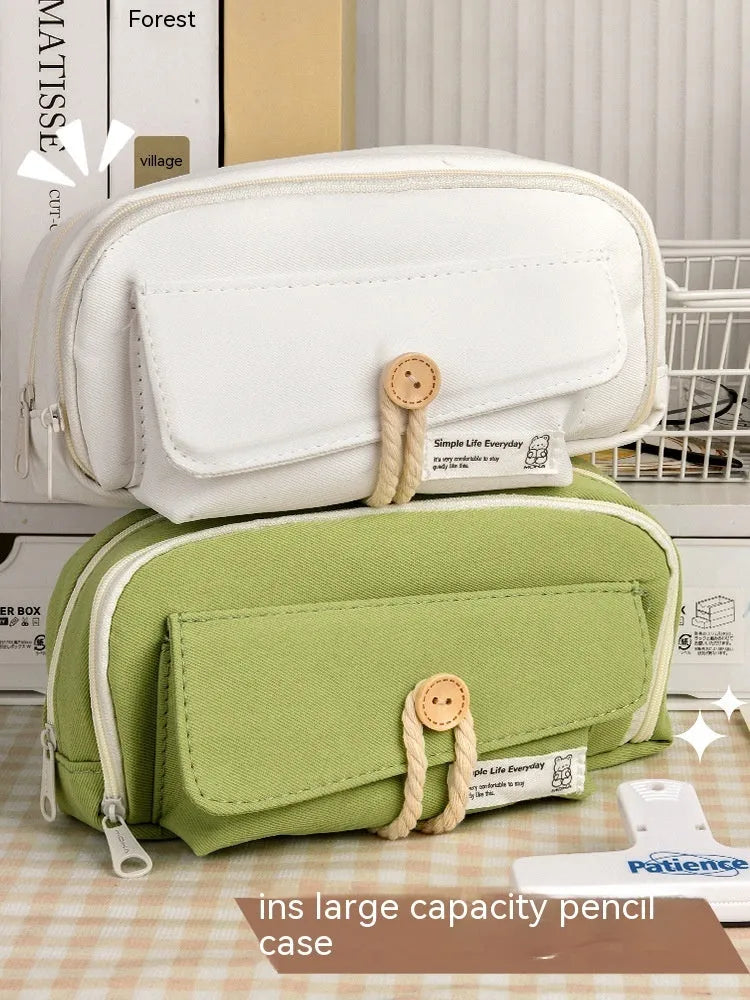 Large capacity canvas pencil case for girls in beige, blue, gray, or green, holding many pens.