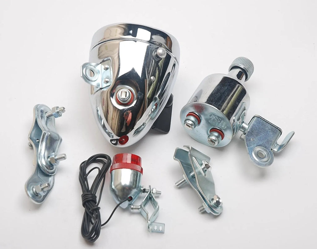 Silver bicycle dynamo generator light kit mounted on a bicycle frame with headlight and taillight.