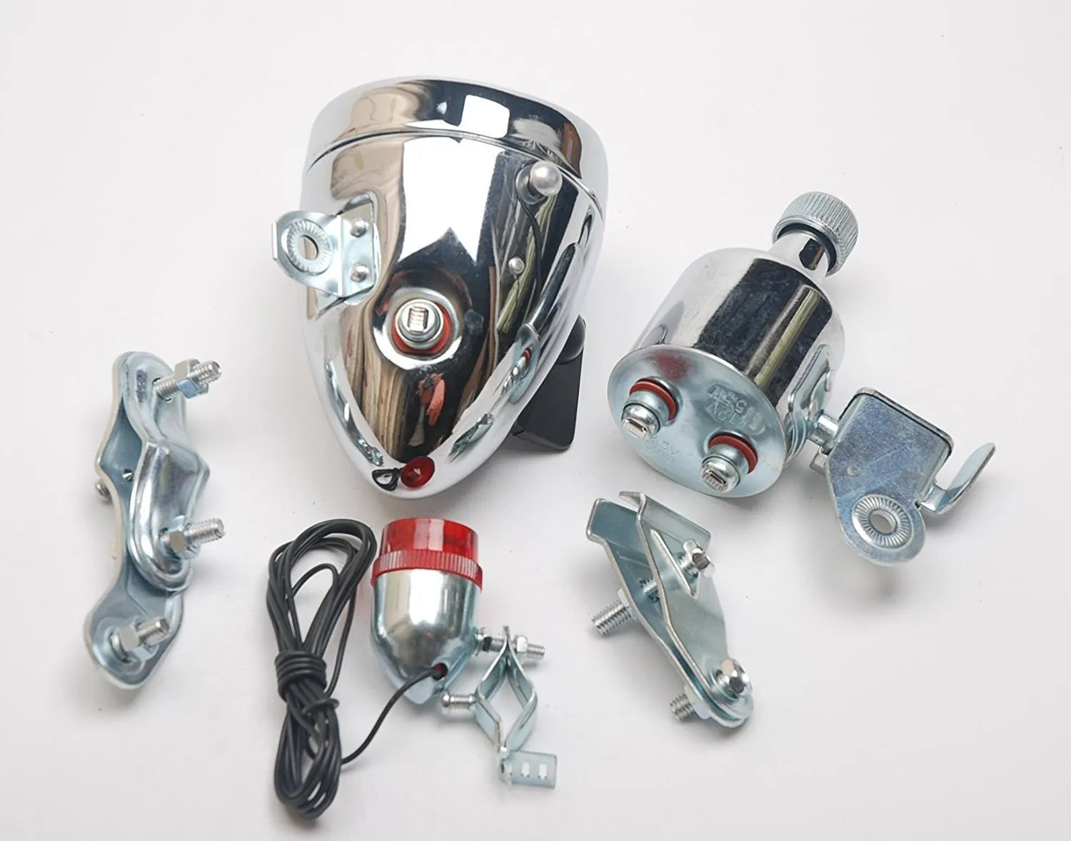 Silver bicycle dynamo generator light kit mounted on a bicycle frame with headlight and taillight.
