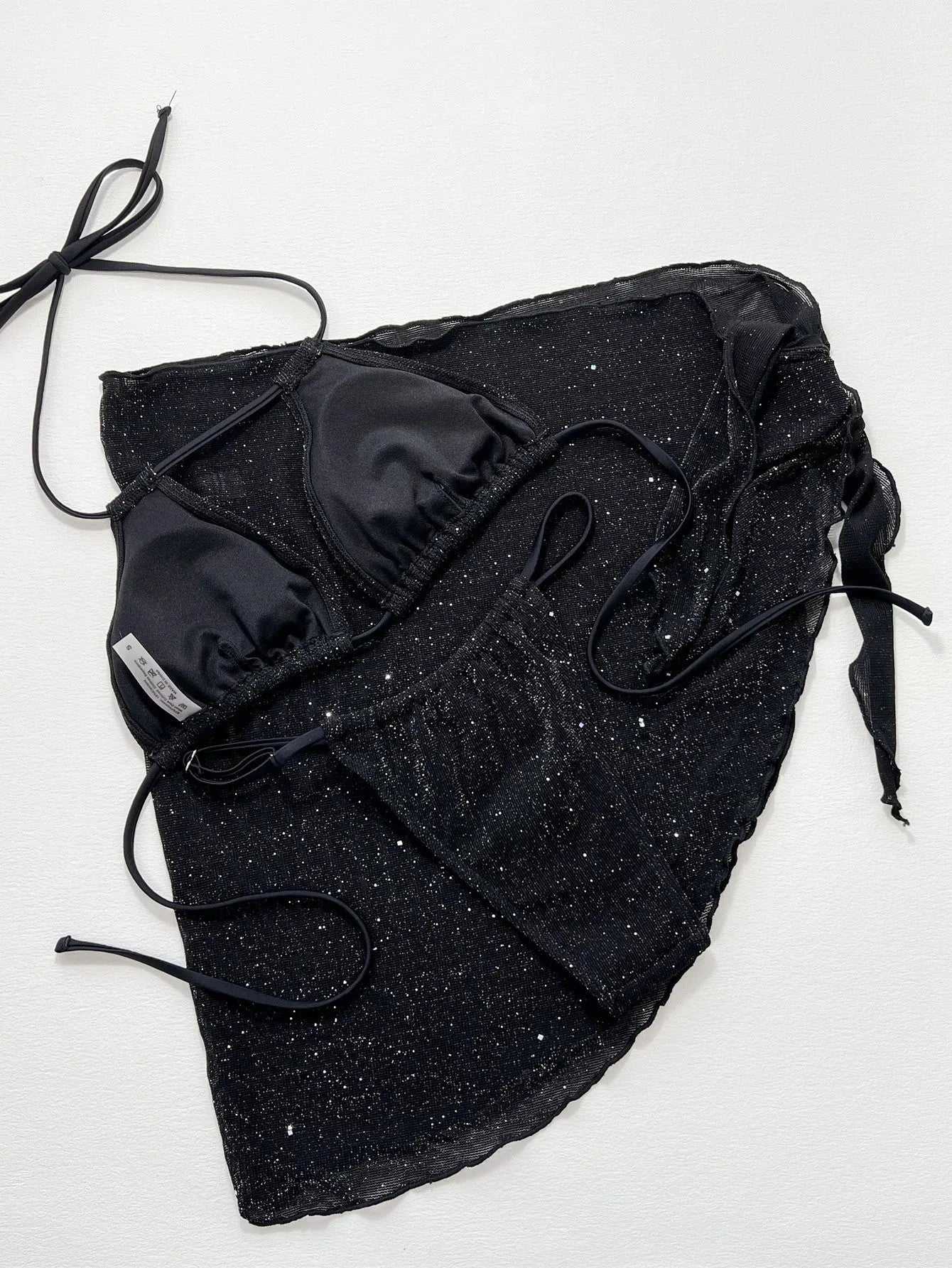 Black three-piece swimsuit bikini set with adjustable top and matching shorts