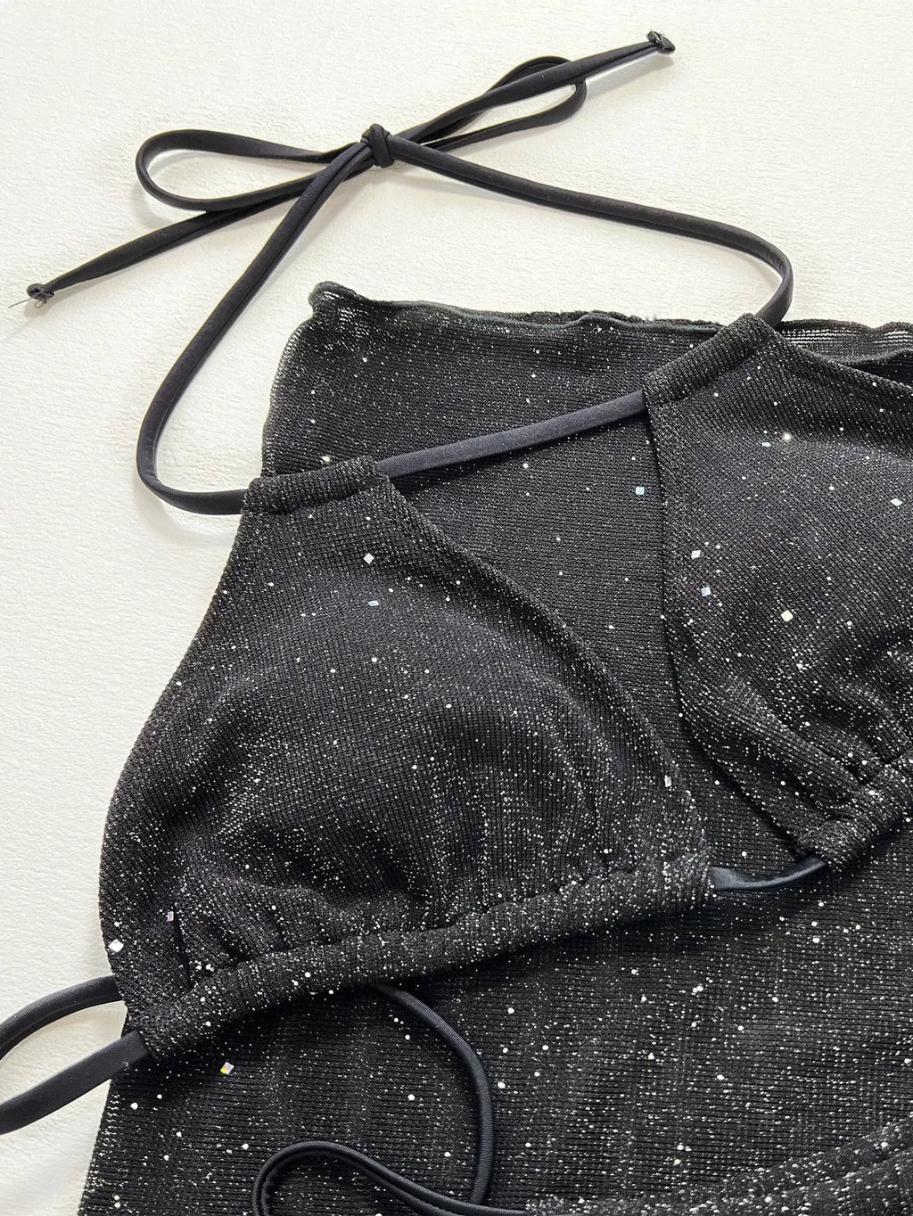 Black three-piece swimsuit bikini set with adjustable top and matching shorts