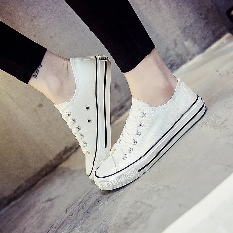 Women's casual canvas shoes in solid colours: all-black, black, white-black, and white-red.