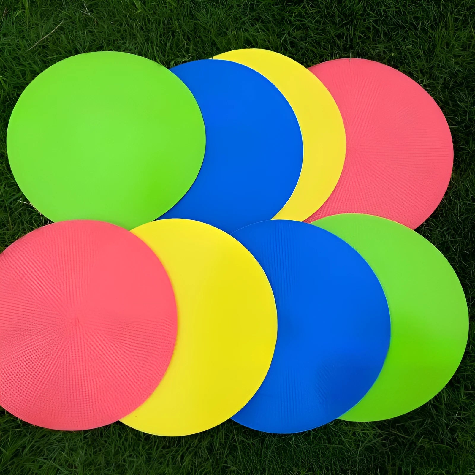 Multi-colour 23 cm diameter soft TPE football training target disc on grass