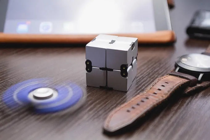 Zinc alloy infinity cube fidget toy in black finish showing rotating cube mechanism