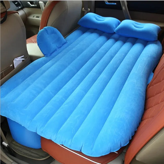 Universal inflatable car bed with flocked cloth, shown with two pillows and a pump.