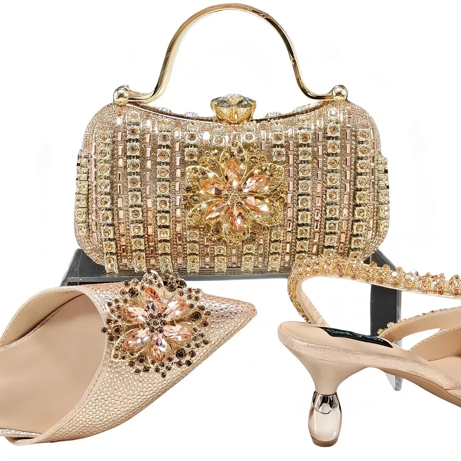 Women's black high heel and matching clutch bag set with floral decoration and rhinestones.
