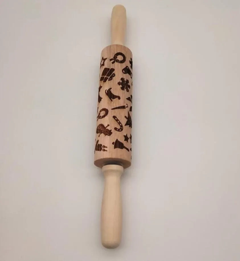 Wooden rolling pin with embossed Christmas patterns including reindeer and snowflakes on a 45cm length.