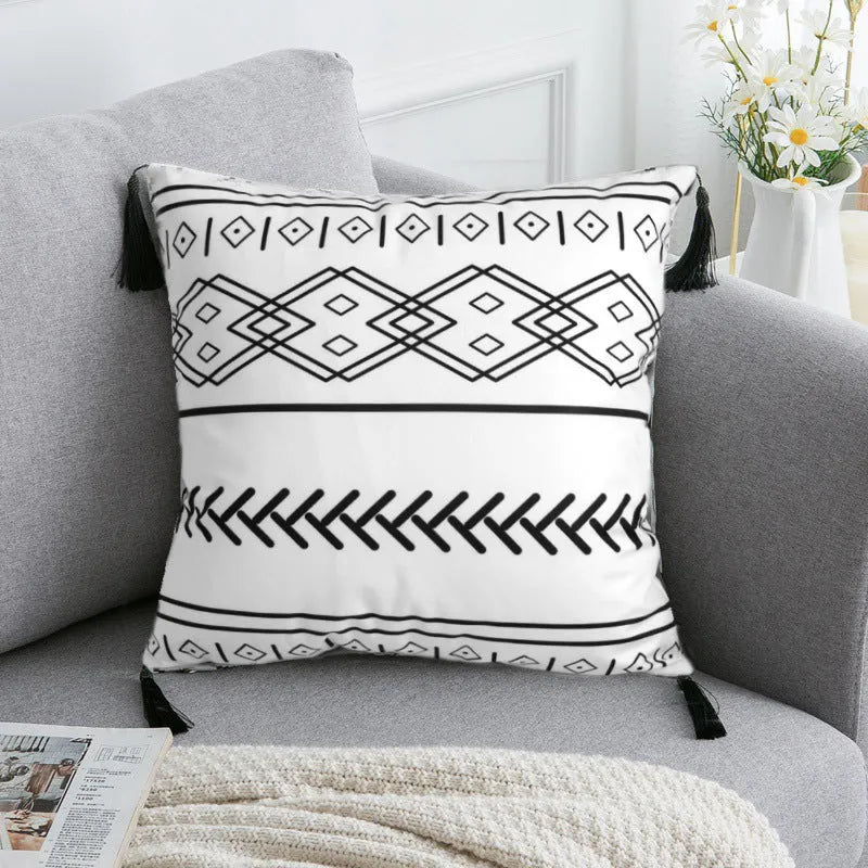 Bohemian national style throw pillow cushion cover in light grey on a sofa.