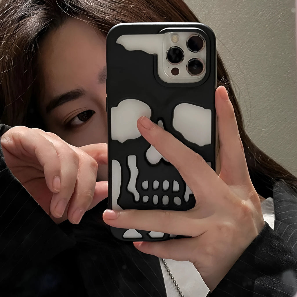 Frosted skull TPU phone case in matte black for iPhone 14 Pro showing hollow skull design