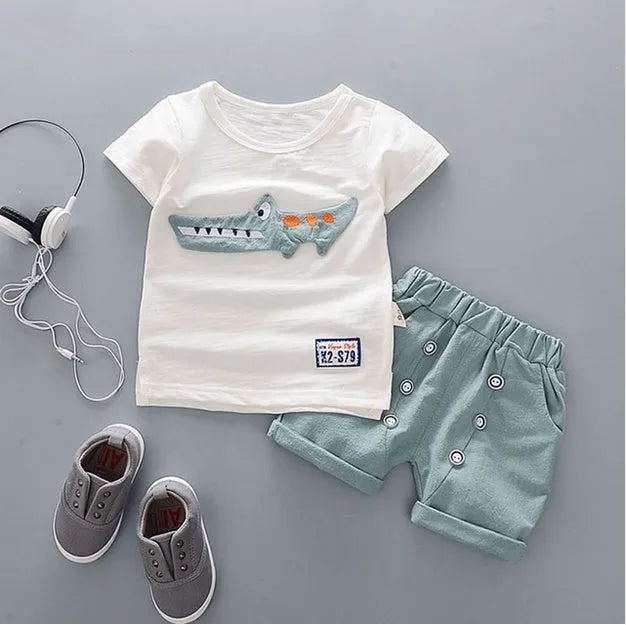 Baby boy wearing a blue cotton short sleeve t-shirt and matching shorts summer outfit
