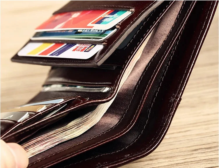 Men's black leather RFID blocking wallet open to show card slots, ID window, and coin pocket.