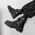 Men's solid black platform Dr. Martens ankle boots with side zipper and eight eyelets.