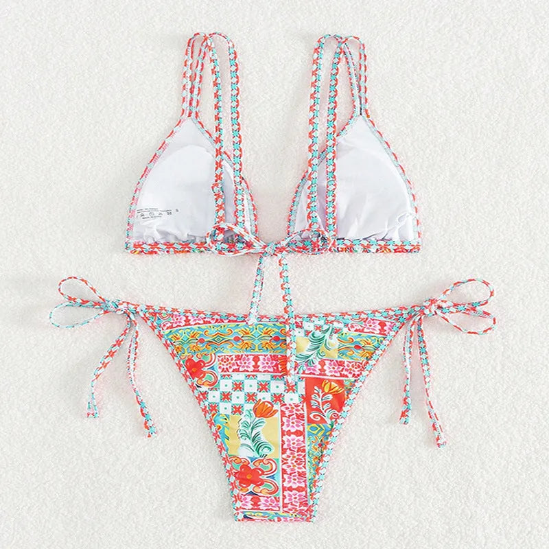 Women's lace-up split swimsuit in picture colour, showing backless design and adjustable ties.