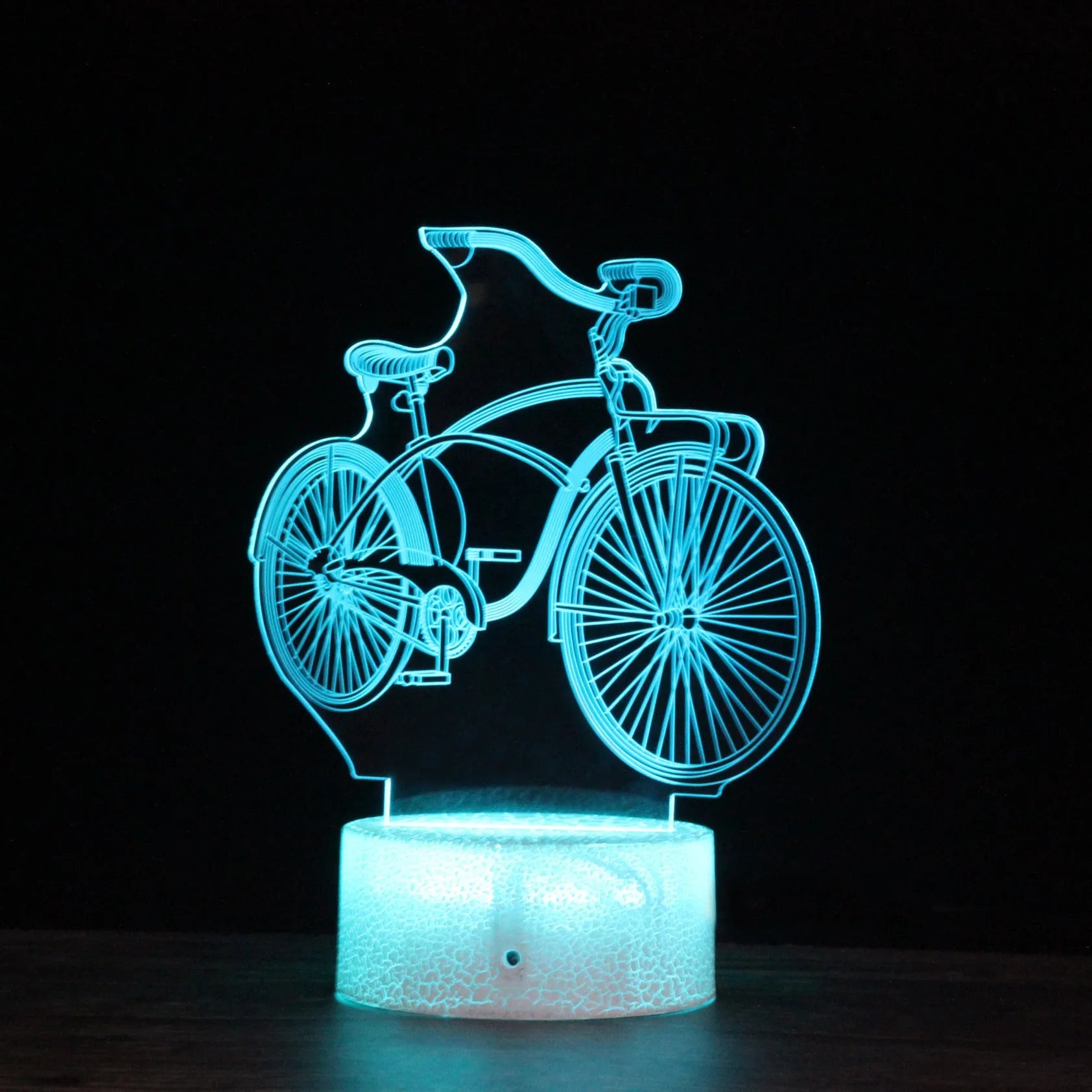 3D bicycle night light with LED acrylic shade on black base against a dark background
