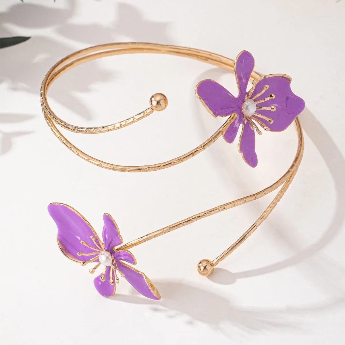 Close-up of a pink alloy fashion arm ring with a hollow armband lines pattern design.