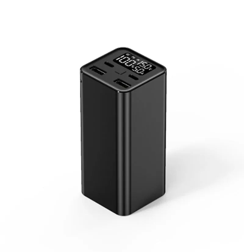 A black metal 65W laptop power bank with 20000mAh capacity, showing size compared to a hand.