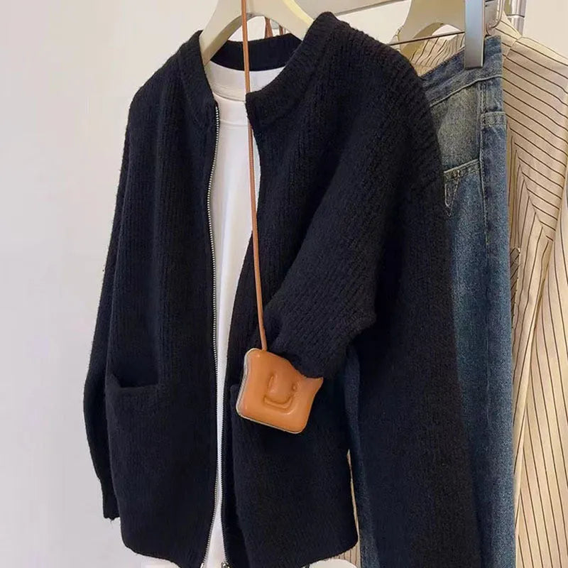Beige viscose sweater coat cardigan with long sleeves on a hanger.