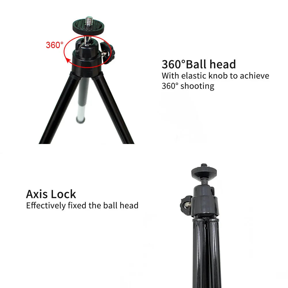 Black mini flexible tripod extended on a table with a silver U-shaped phone clip attached.