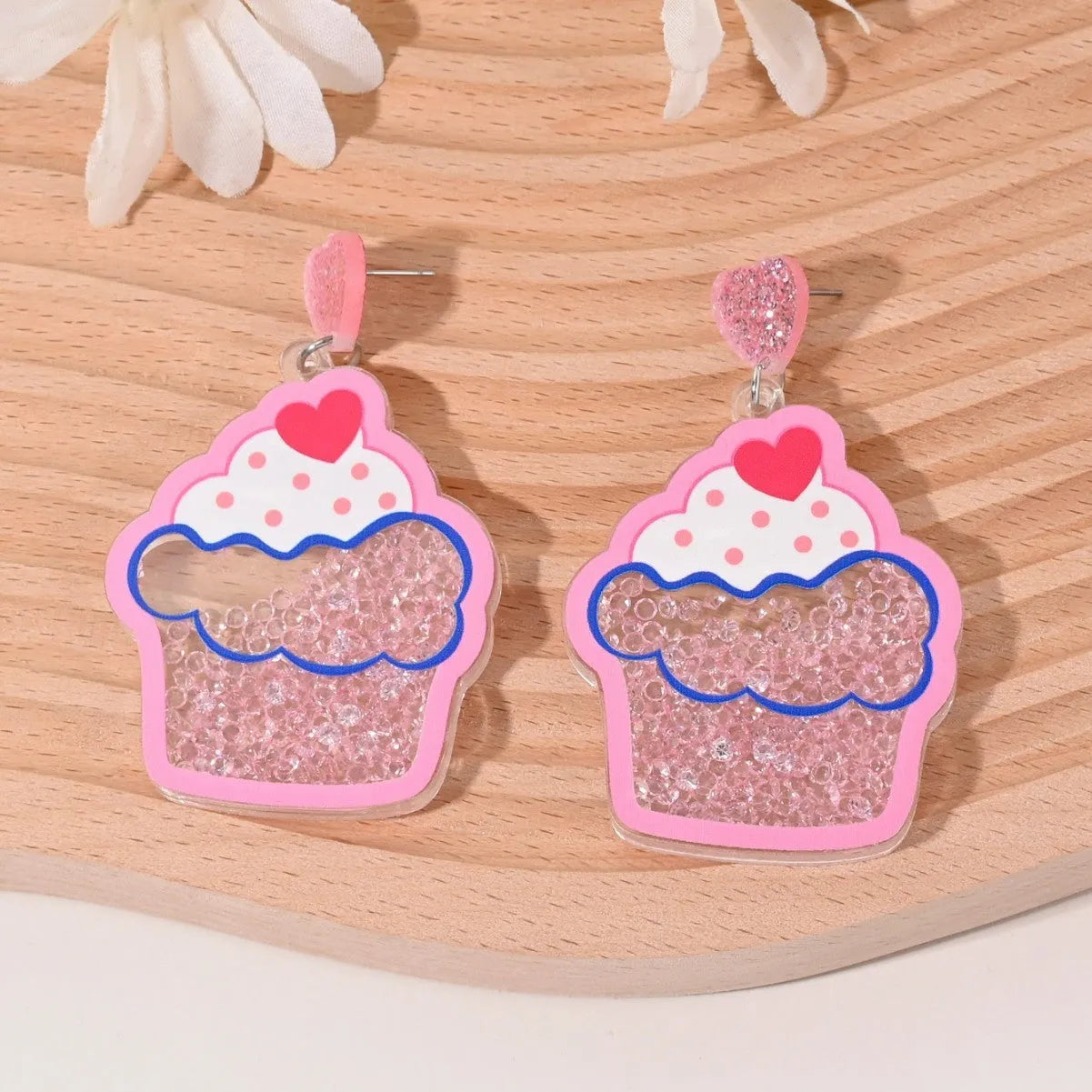 Colourful acrylic earrings with realistic fruit and dessert charms including cherry, strawberry, and ice cream.