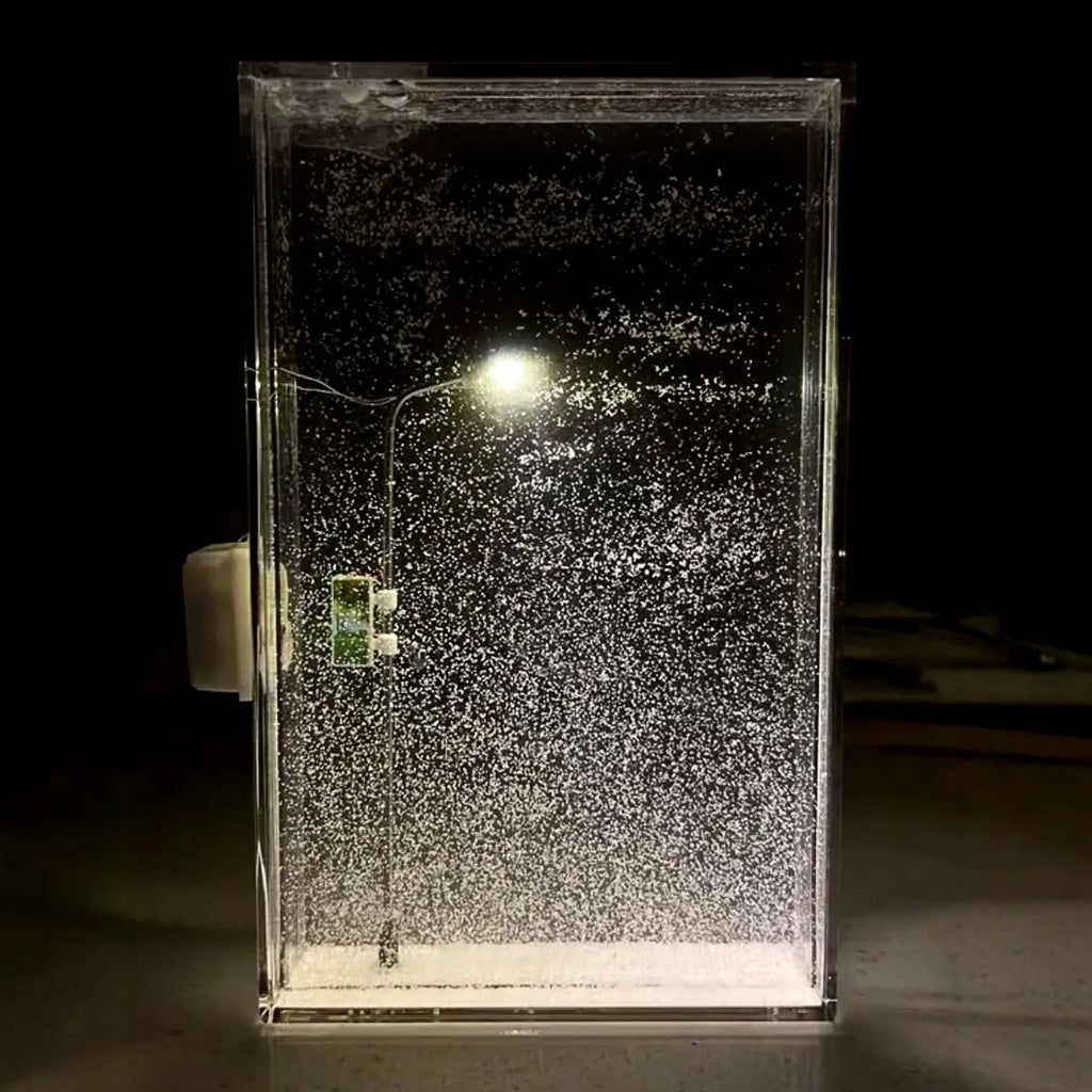 DIY snowy landscape Christmas night light with flowing snow effects and small street lamps on desktop