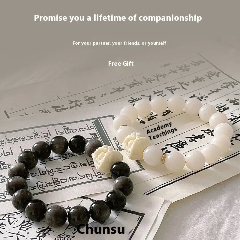 Handcrafted Xingshi obsidian prayer bead bracelet with chamfered square grain design, shown in 12mm size.