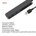 Black USB 3.0 hub with four ports and a 30 cm attached cable on a desk.