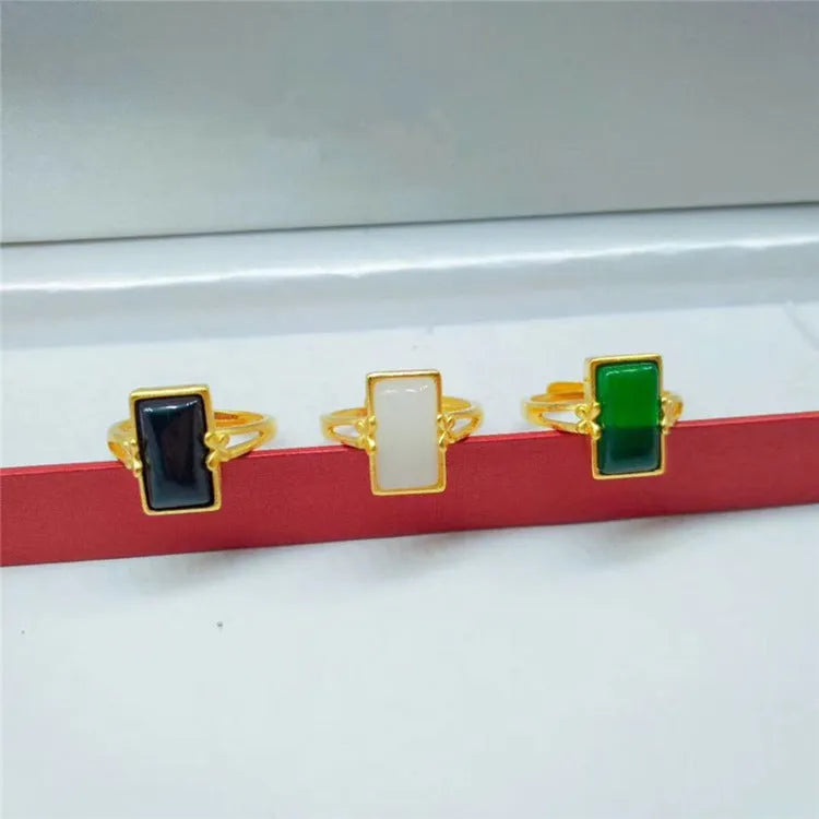 Adjustable brass gold-plated ring with a long green gemstone in a national style setting.