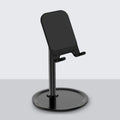 Aluminium alloy and plastic foldable stand holding a tablet on a desk