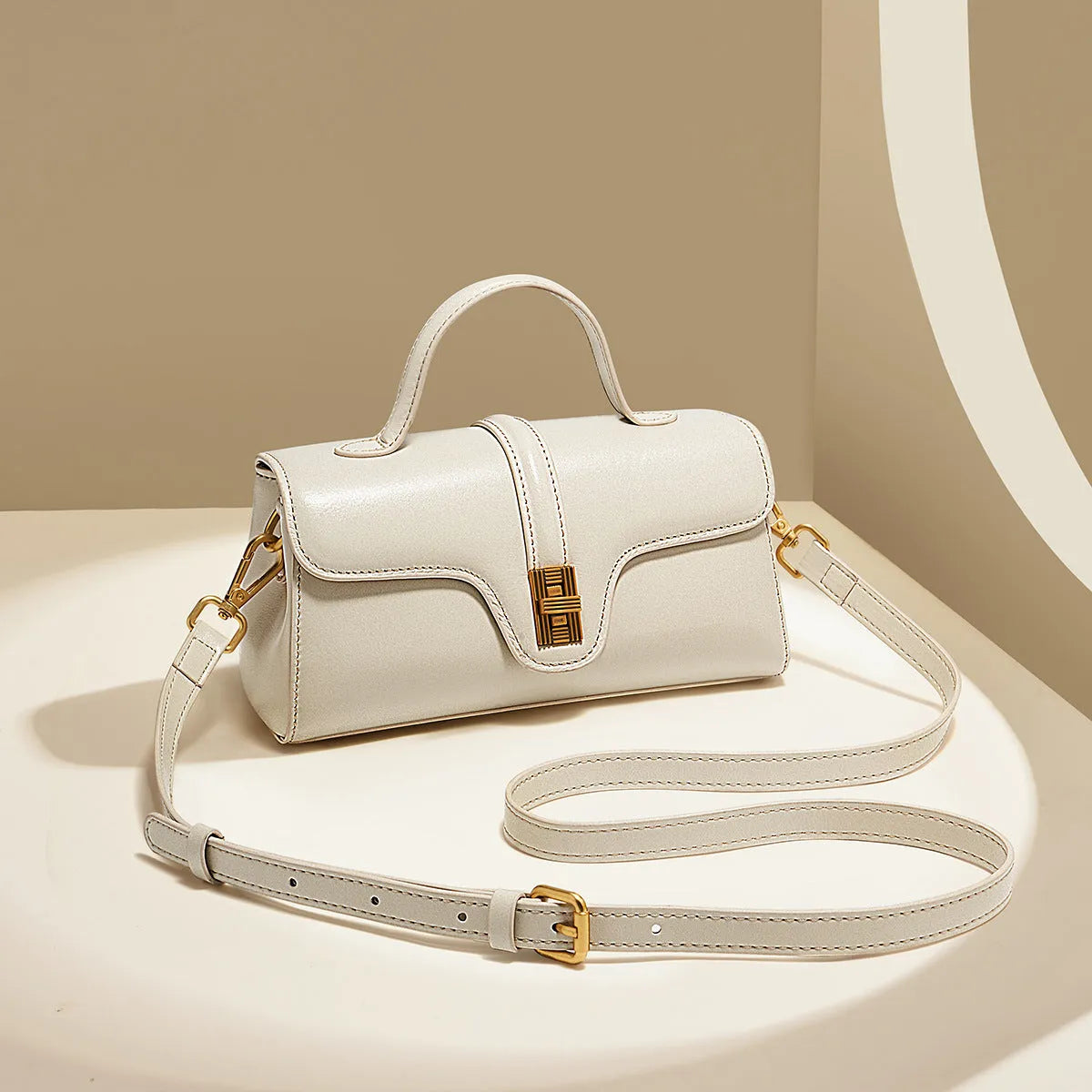 Cambridge-style leather messenger bag in clamshell design with lock detail and internal compartments