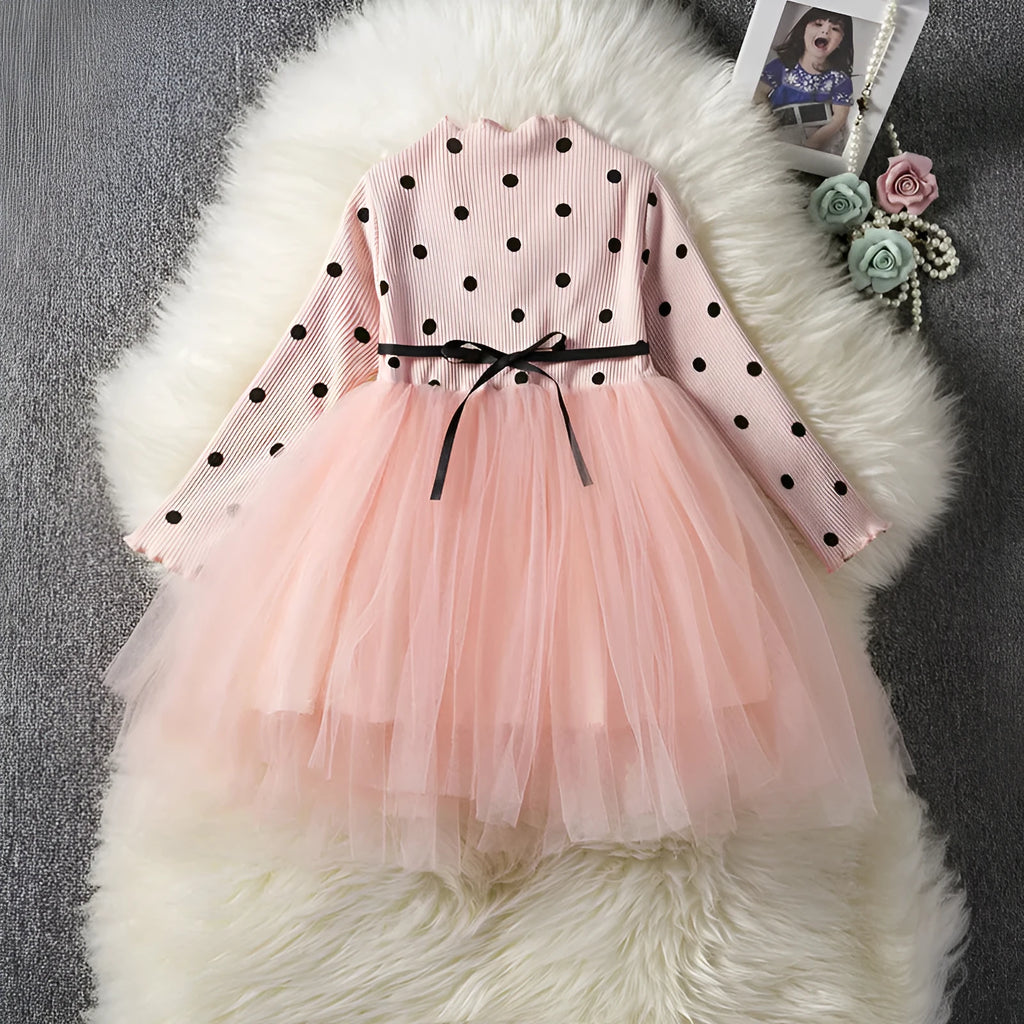 Baby girl in a long sleeve white lace tutu dress for a christening or birthday party.