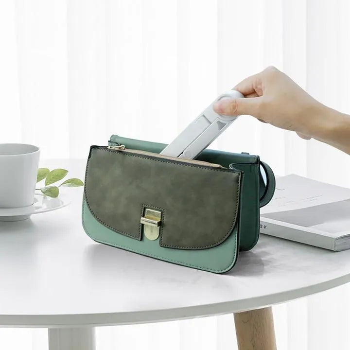 Black foldable tablet holder standing upright holding a tablet, shown next to its folded flat profile.